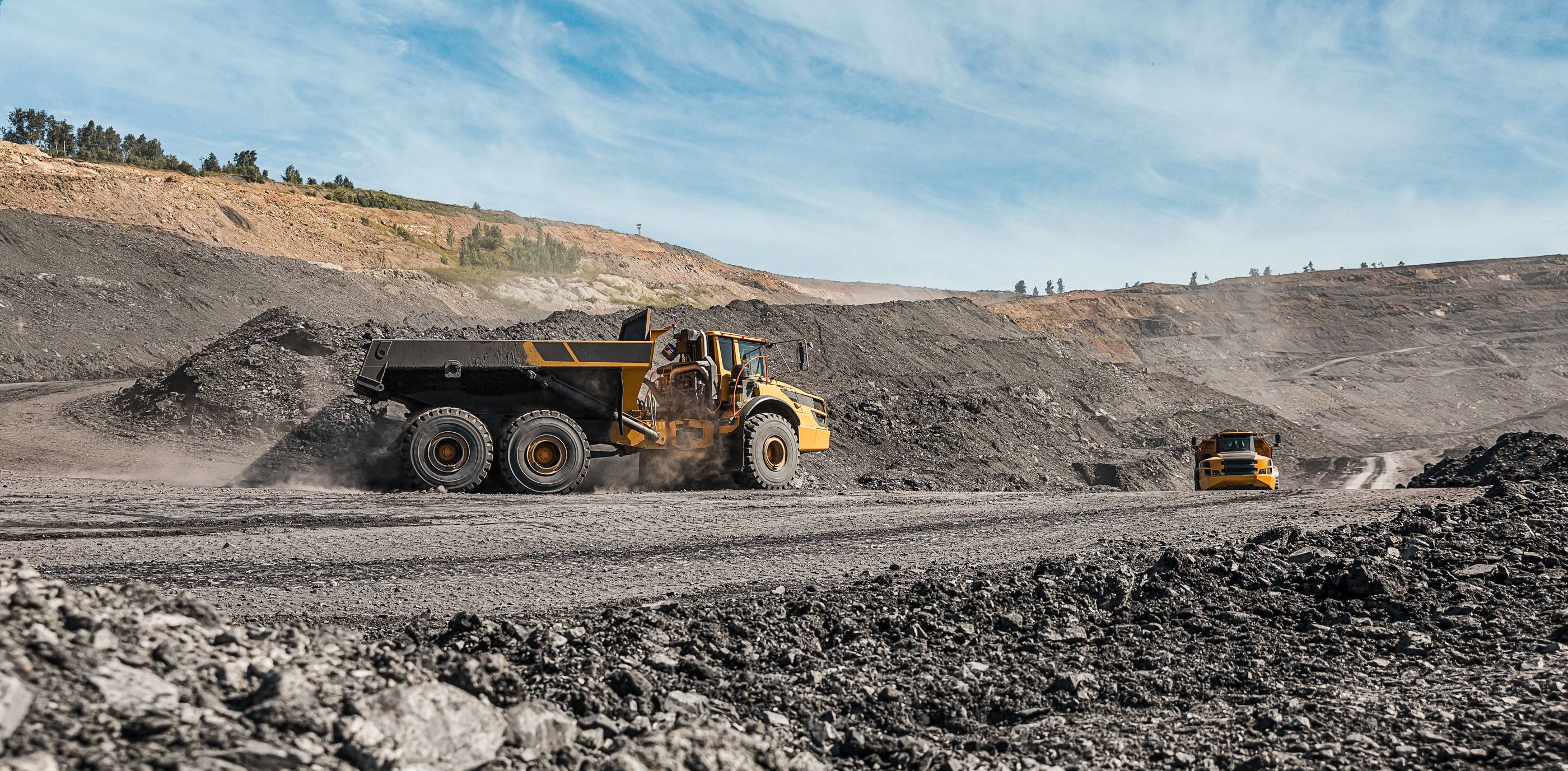 Большой карьерный самосвал. Загрузка породы. Погрузка угля в кузов. Карьерная техника и экскаватор для транспортировки угля из разреза.